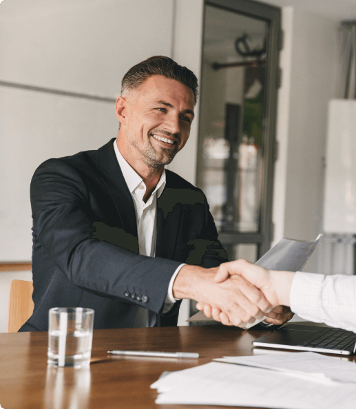 Business professional shaking hands, representing global recruitment and partnership services.