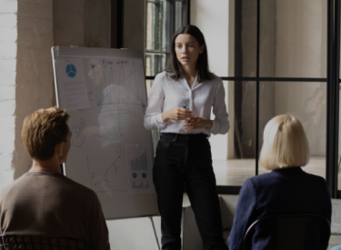 Several people in a meeting, representing discussions and planning for the Dream Worldwide Jakarta event exposition
